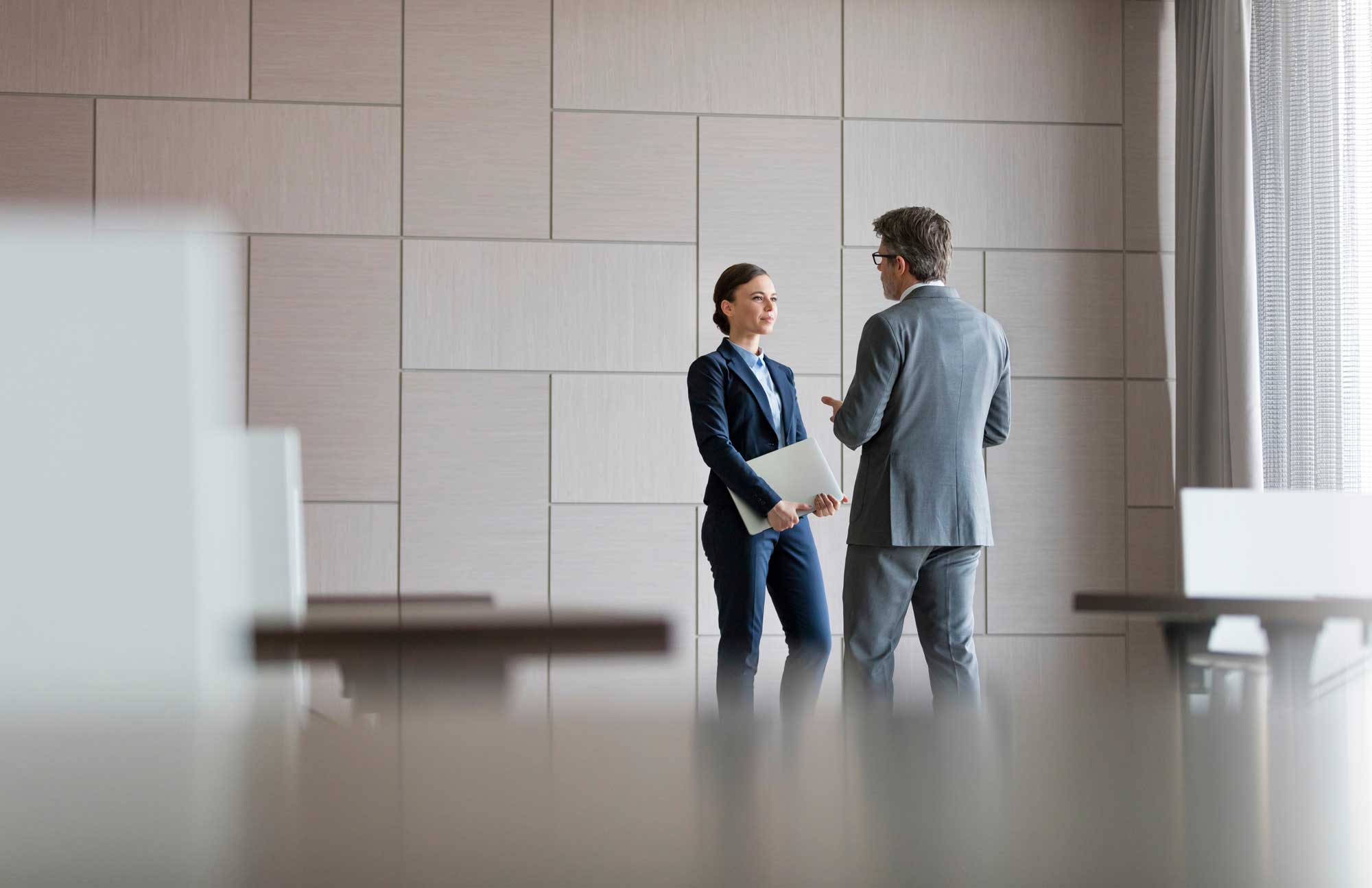 businessman-and-businesswoman-talking-in-conference-room