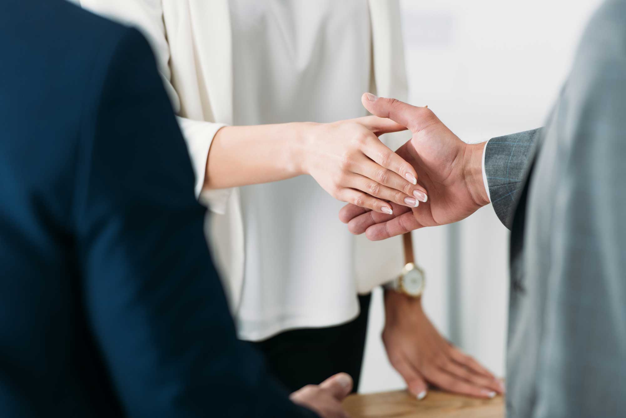 selective-focus-of-man-and-woman-shaking-hands-at-office